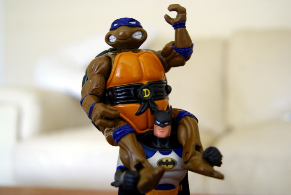 Batman carrying a Ninja Turtle