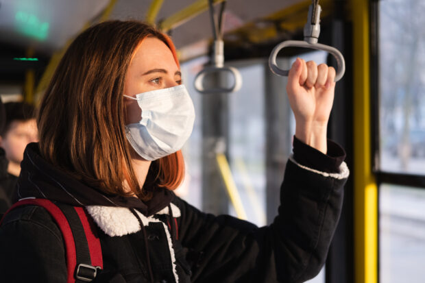 Woman in a protective mask on the train